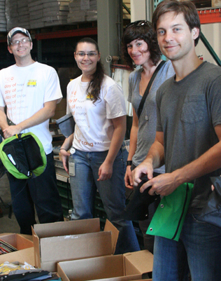 Tobey Maguire joined over 50 Holland America employees to sort supplies and stuff backpacks.