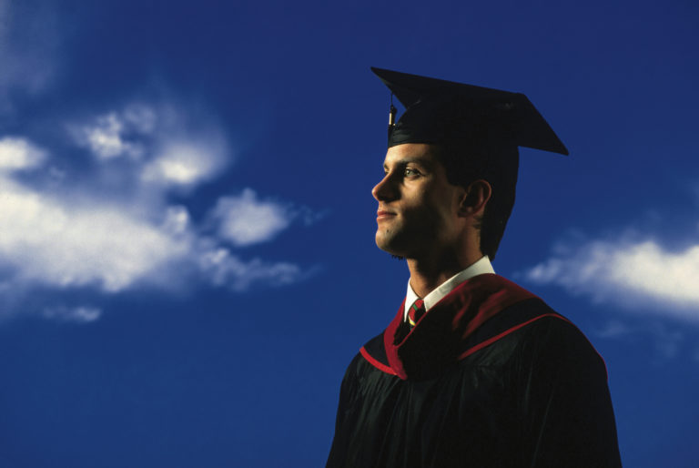 Young man in graduation cap and gown