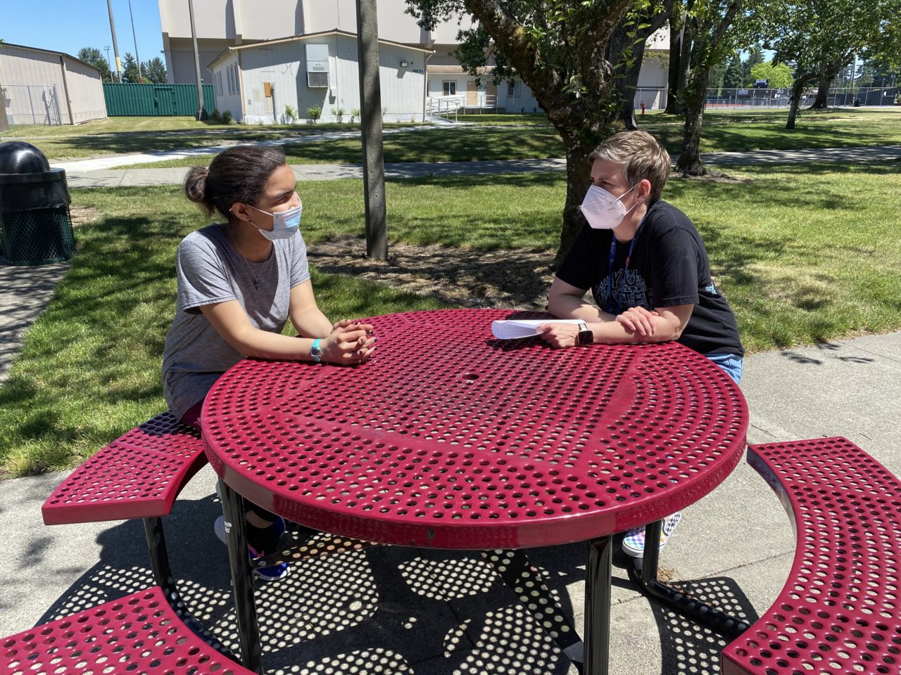 Student and mentor chatting outdoors