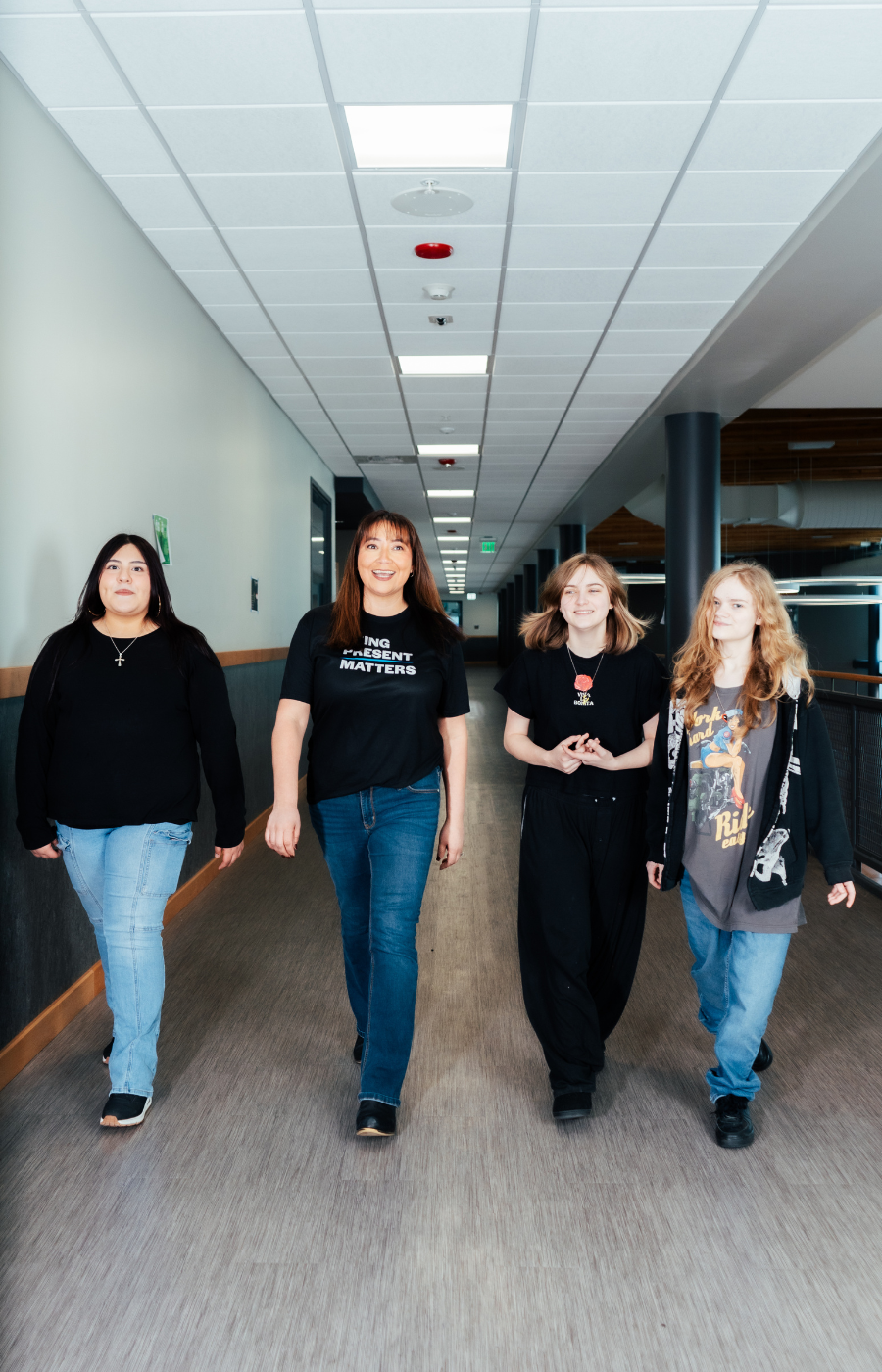 CIS staff and 91国产 walking down a school hallway