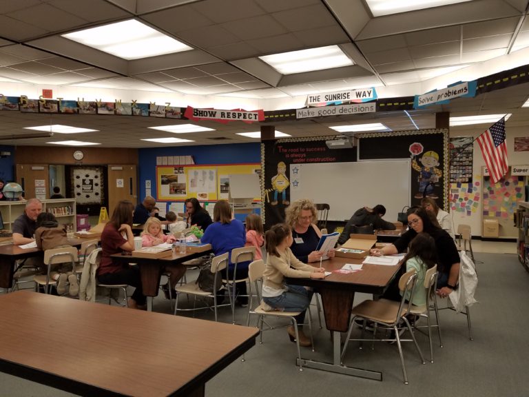 Tutors and students working together in a library