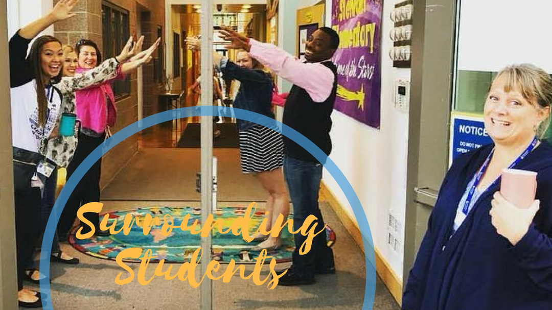 Site Coordinators high five students as they come in the door