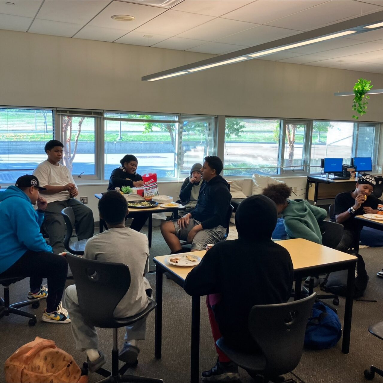 8 student sitting around and on desks for their first FREE YA MIND group meeting at Gray Middle School.