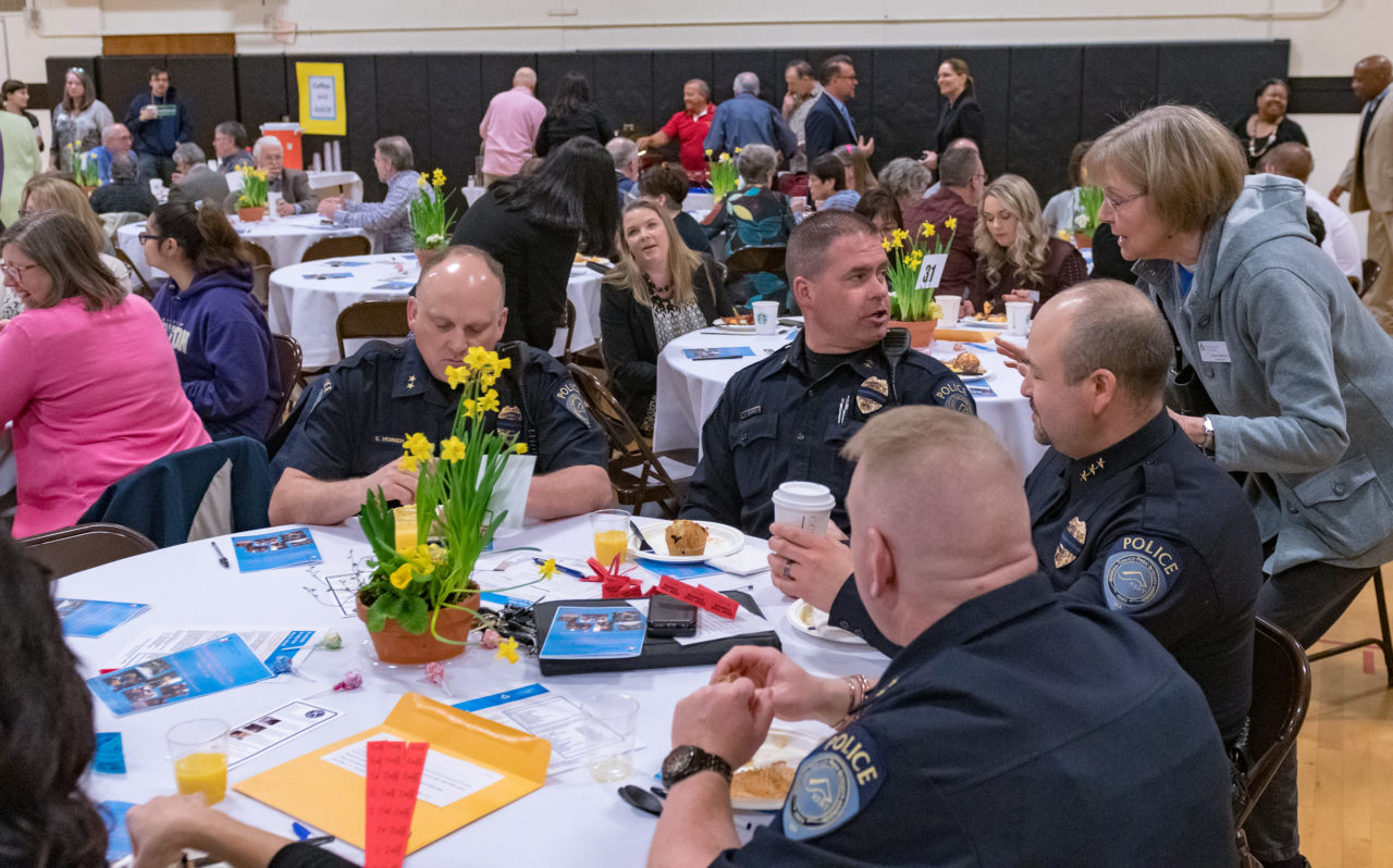 participants from the Breakfast sitting around round tables  