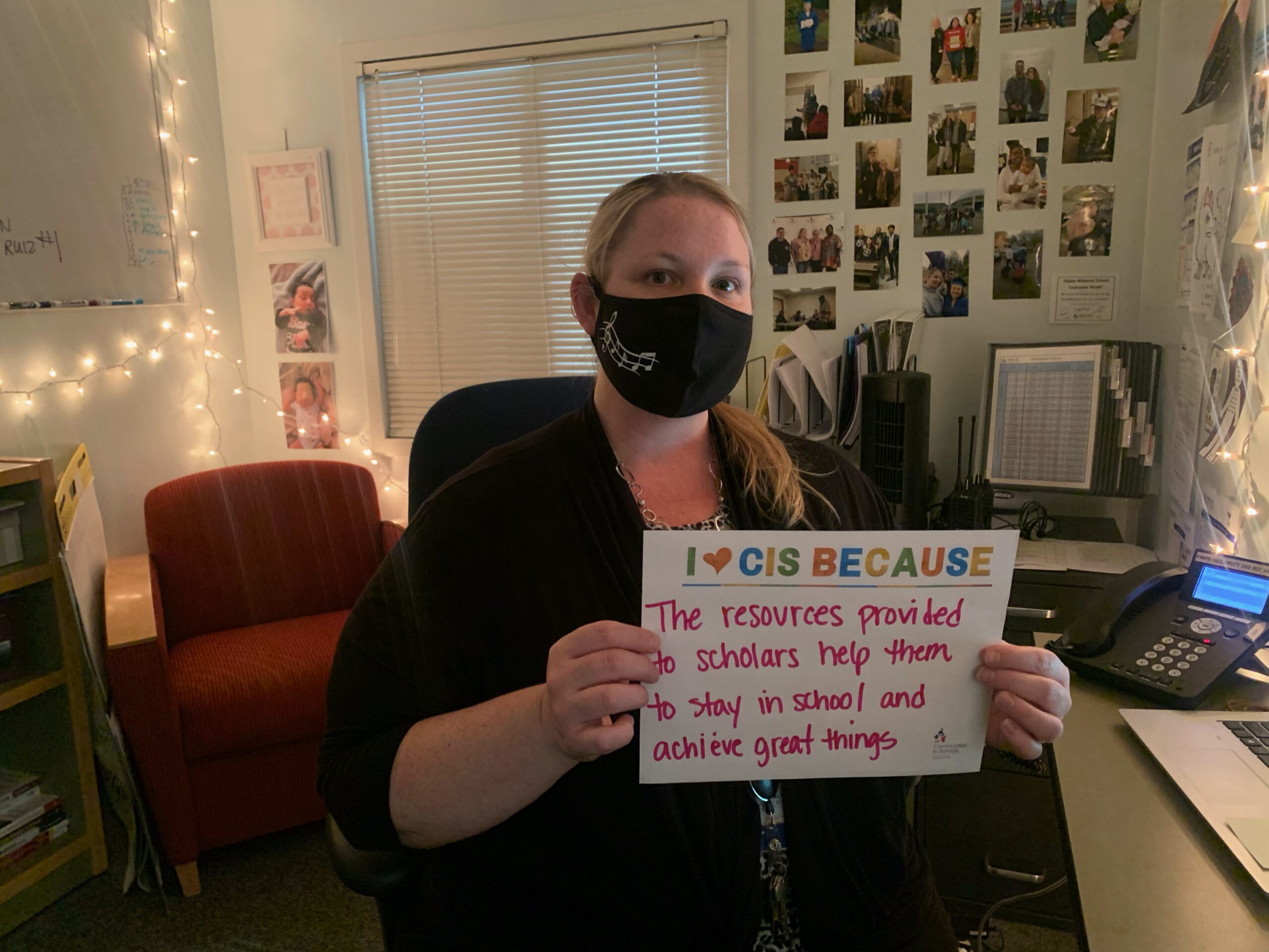 Counselor holing an I heart CIS sign. 