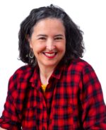 Smiling woman with shoulder length black hair and a red and black checked shirt